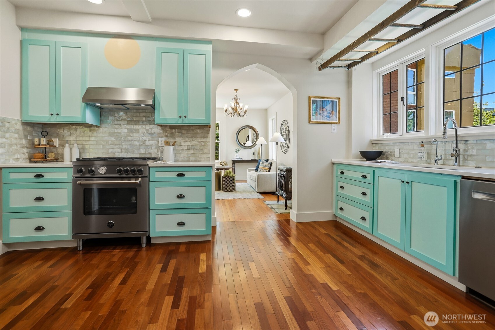 1749 Northwest 63rd Street Seattle, WA 98107 - Photo 6 of 40 a kitchen with stainless steel appliances granite countertop a stove and a wooden floors