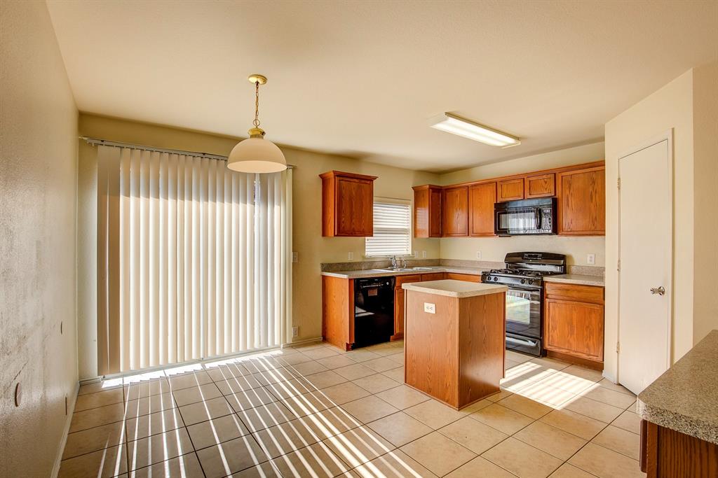 1720 Desperado Road Fort Worth, TX 76131 - Photo 13 of 40 a kitchen with stainless steel appliances granite countertop a stove top oven a sink dishwasher and a refrigerator with wooden floor