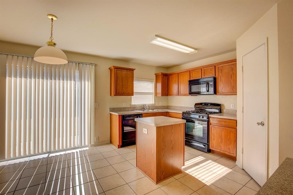 1720 Desperado Road Fort Worth, TX 76131 - Photo 15 of 40 a kitchen with stainless steel appliances granite countertop a stove a sink and a refrigerator