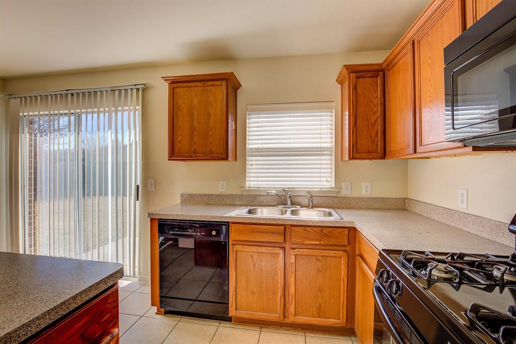 1720 Desperado Road Fort Worth, TX 76131 - Photo 16 of 40 a kitchen with a stove and a sink