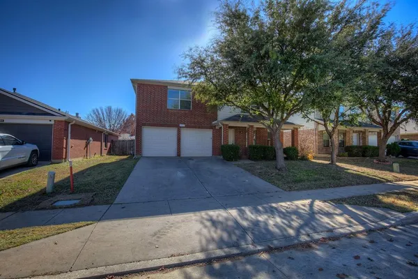 a front view of a house with a yard and a garage