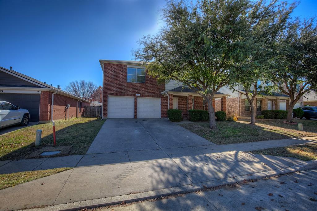1720 Desperado Road Fort Worth, TX 76131 - Photo 2 of 40 a front view of a house with a yard and a garage