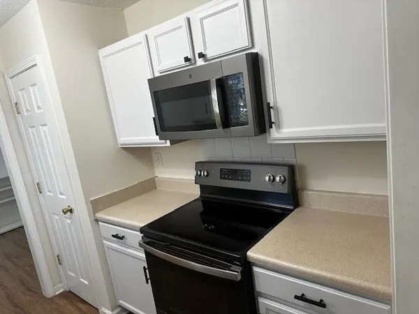 a kitchen with a stove and a microwave