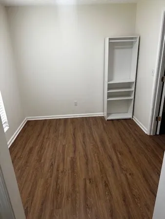 a view of room with wooden floor