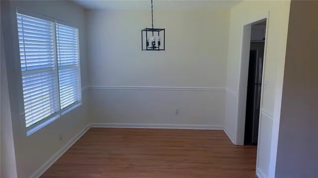 a view of a room with wooden floor and windows