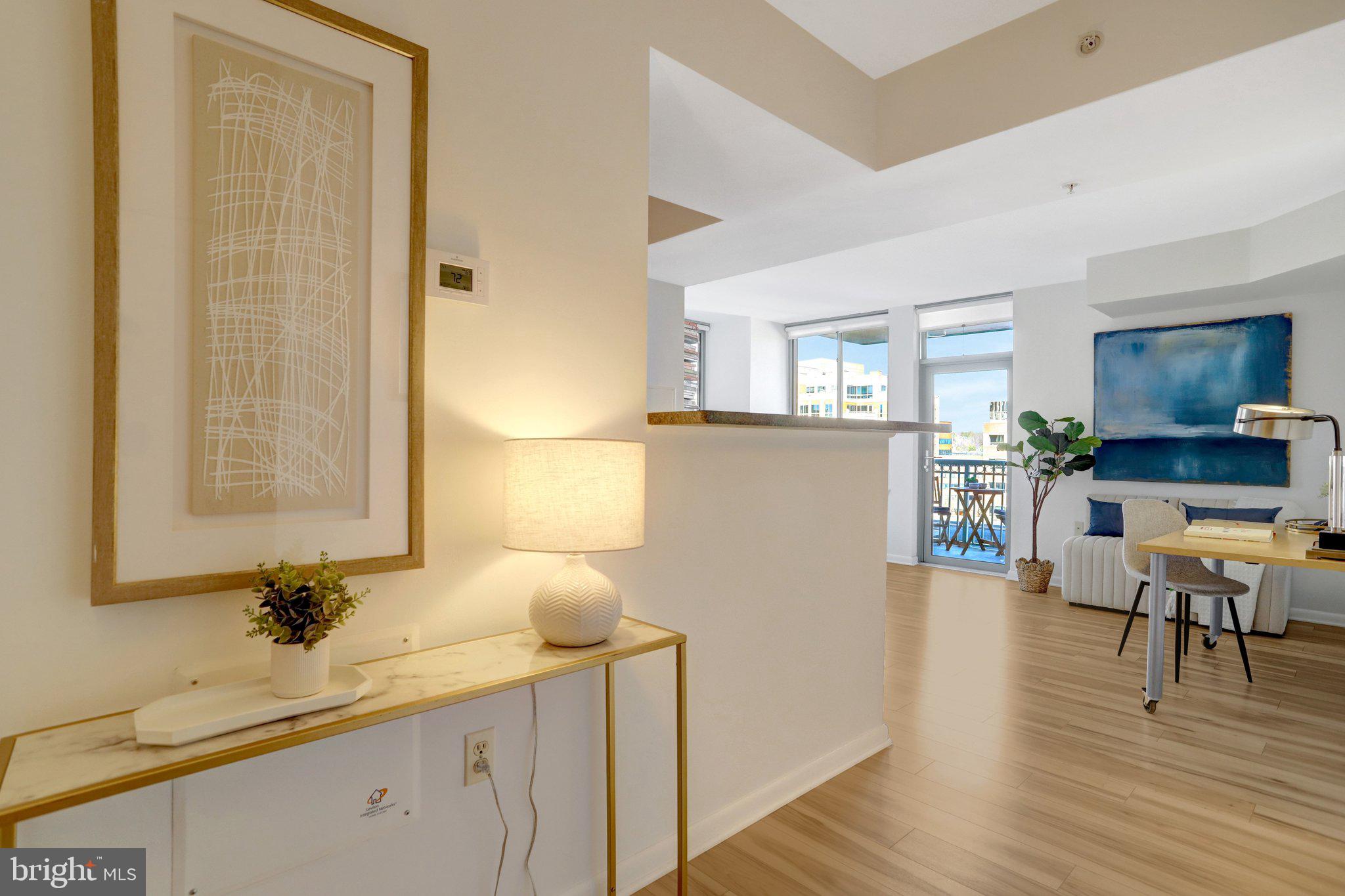 a view of living room with granite countertop furniture and wooden floor