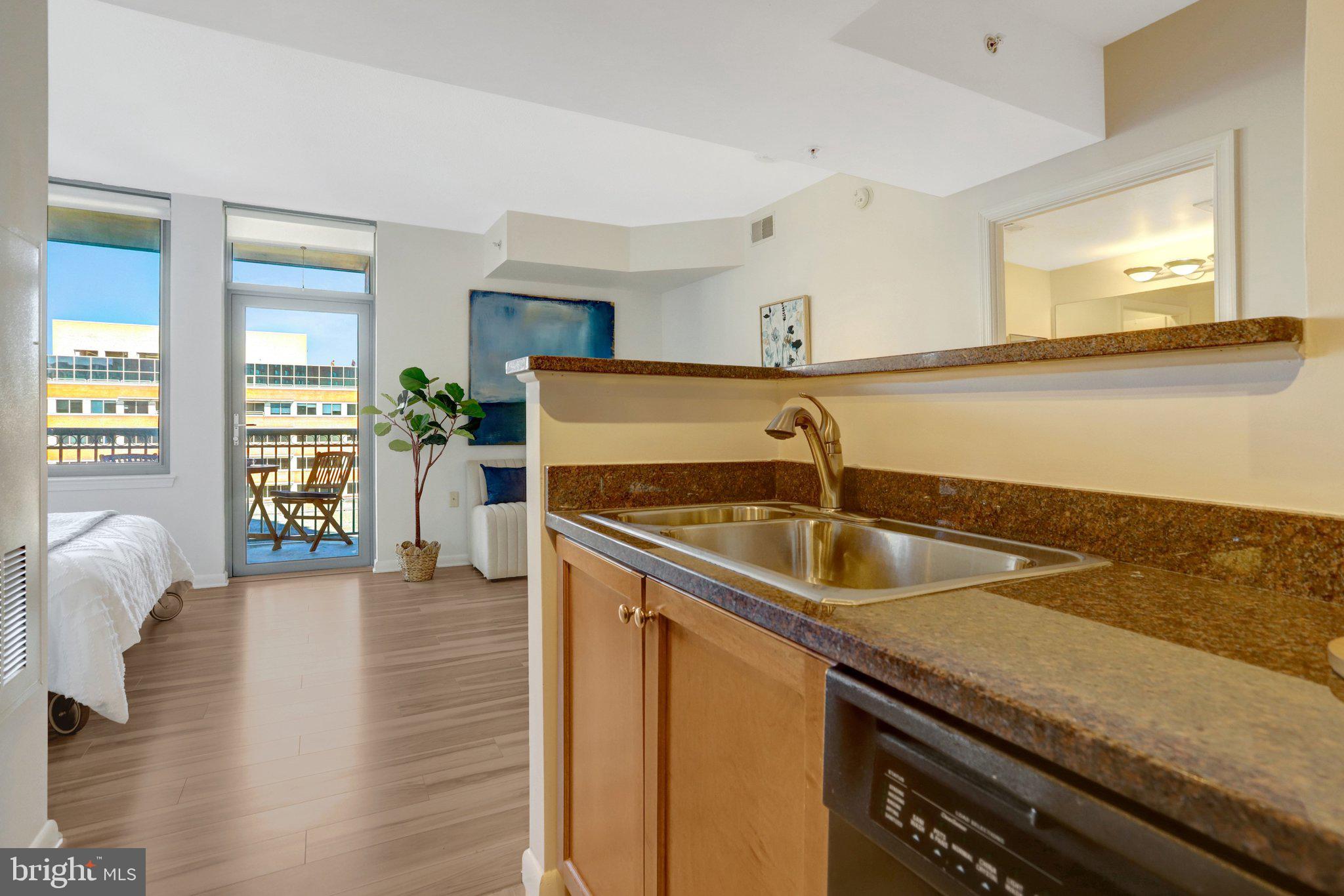 851 North Glebe Road, Unit 812 Arlington, VA 22203 - Photo 11 of 38 a kitchen with a sink and a refrigerator