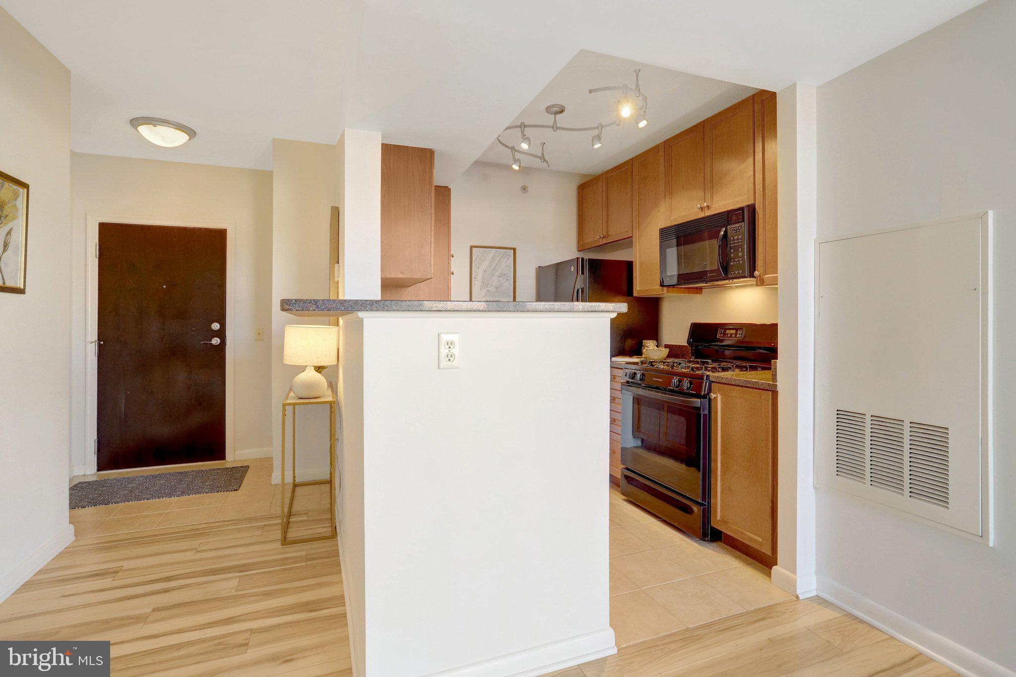 851 North Glebe Road, Unit 812 Arlington, VA 22203 - Photo 13 of 38 a kitchen with stainless steel appliances a refrigerator stove and sink