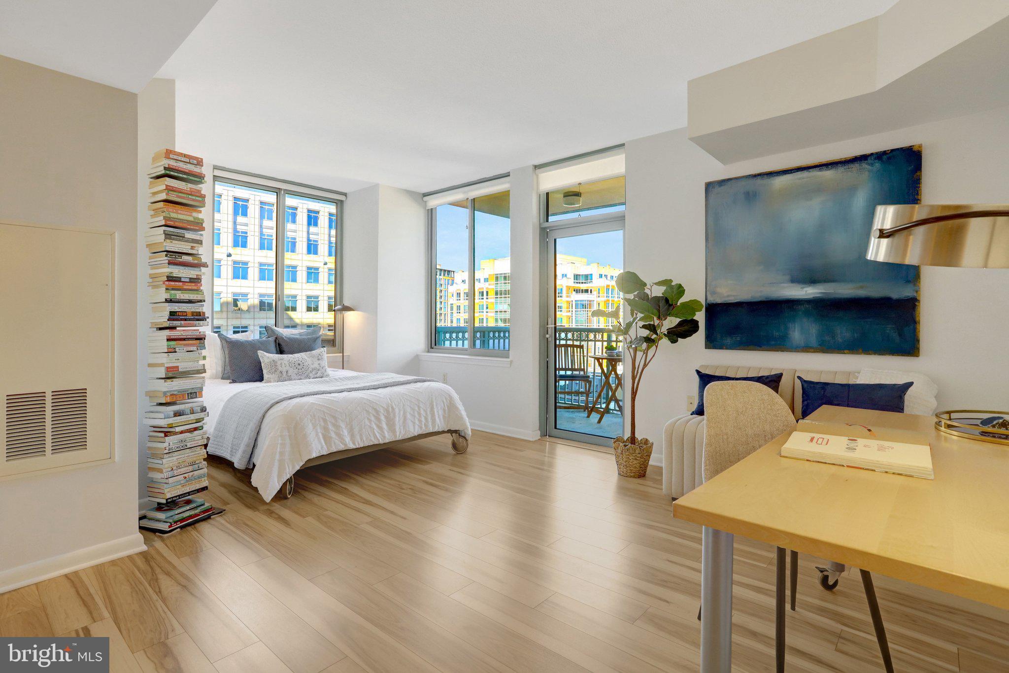 851 North Glebe Road, Unit 812 Arlington, VA 22203 - Photo 2 of 38 a bedroom with a bed and wooden floor