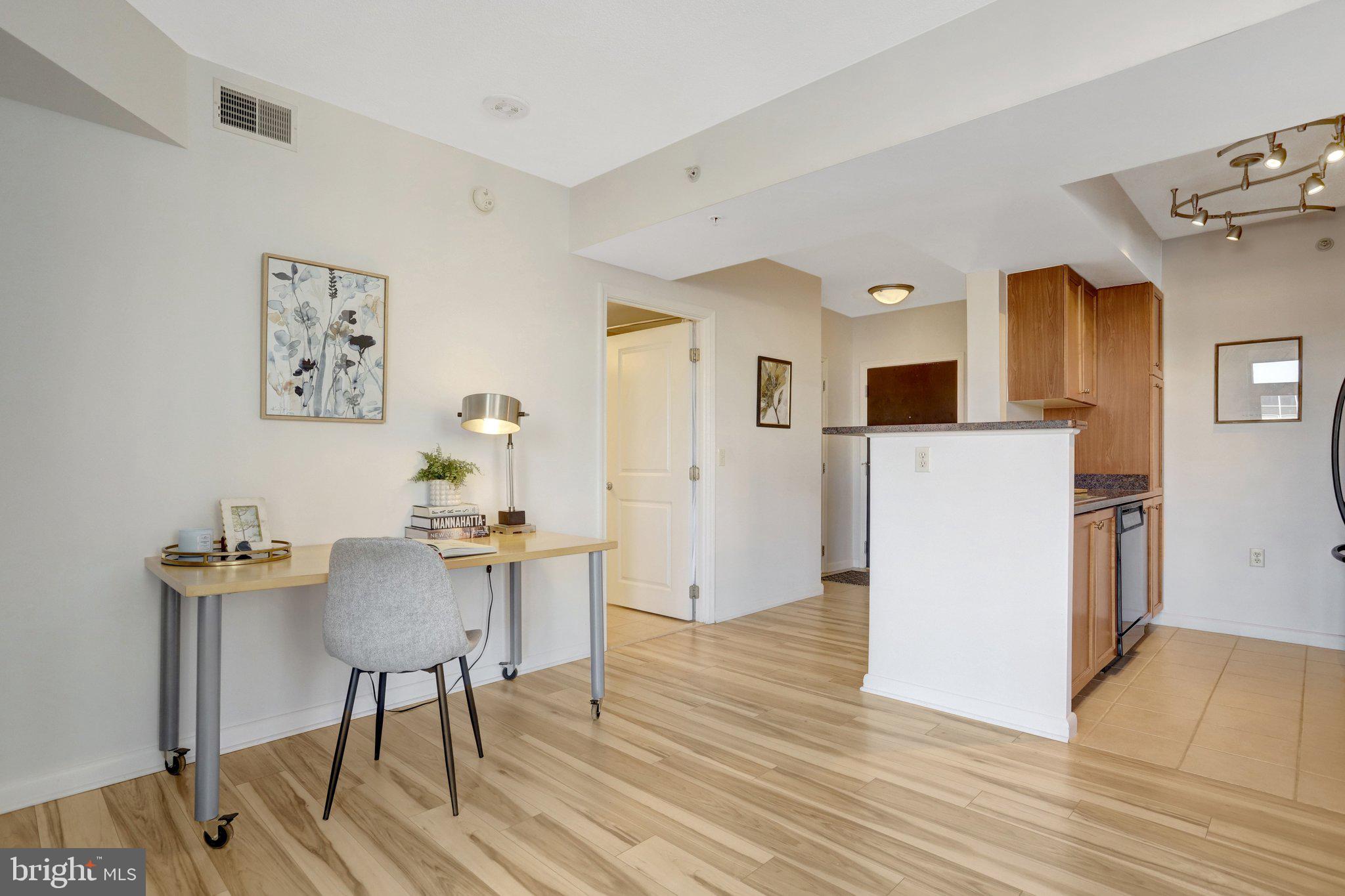 851 North Glebe Road, Unit 812 Arlington, VA 22203 - Photo 4 of 38 a workspace with furniture and wooden floor