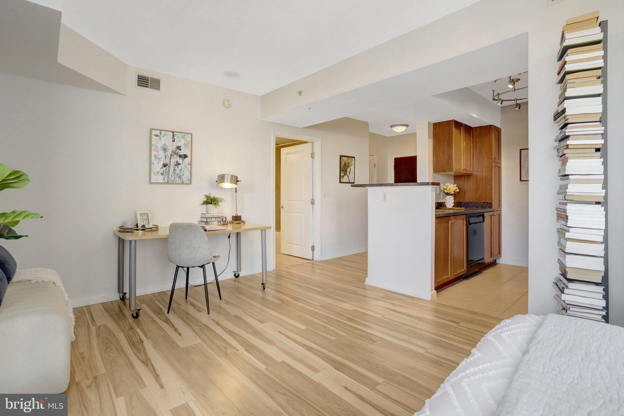 851 North Glebe Road, Unit 812 Arlington, VA 22203 - Photo 5 of 38 a room with furniture and a wooden floor