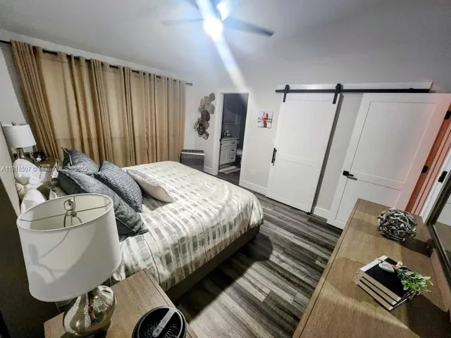 a bedroom with a bed and a mirror