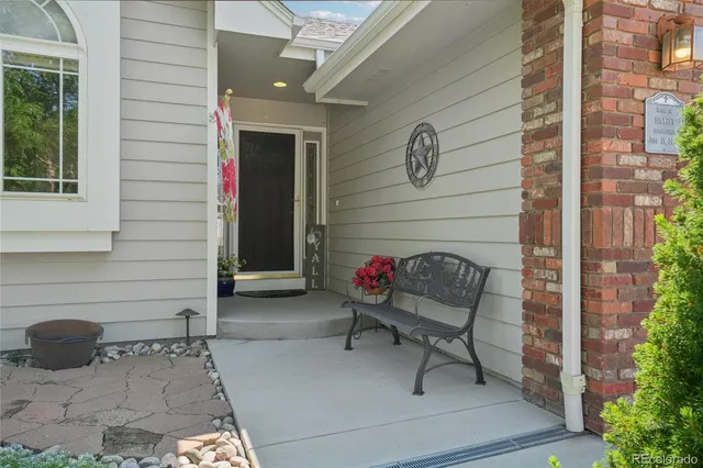 a building outdoor space with patio furniture and potted plants