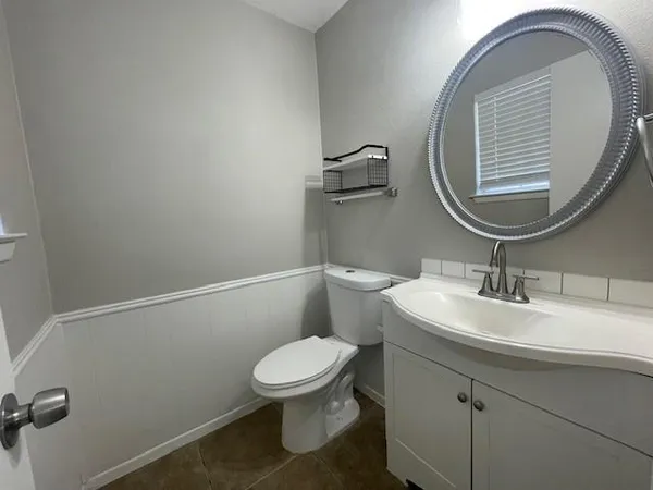 a bathroom with a toilet and a mirror