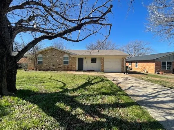 a view of a house with a large window and a yard