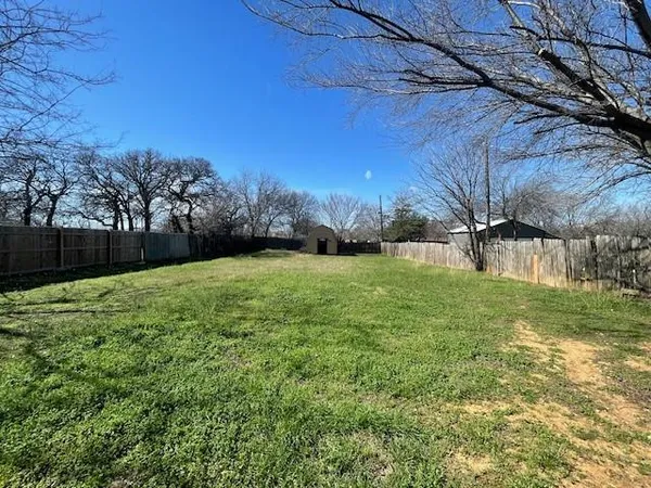 a view of a backyard with large trees