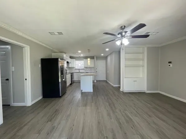 a view of kitchen with refrigerator microwave and wooden floor