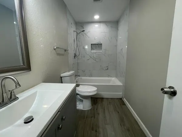 a bathroom with a sink toilet and shower