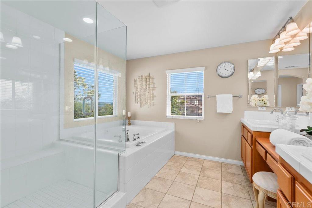 838 Luminara Way San Marcos, CA 92078 - Photo 38 of 54 a bathroom with a tub sink and mirror