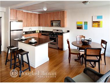 a kitchen with a stove a refrigerator and a dining table