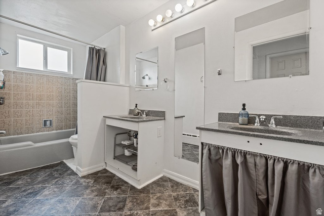 149 West 1600th Street South Mapleton, UT 84664 - Photo 24 of 44 Bathroom featuring two vanities, a baseboard radiator, and shower / bath combo with shower curtain