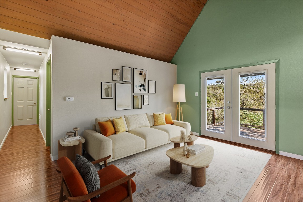 a living room with furniture and wooden floor