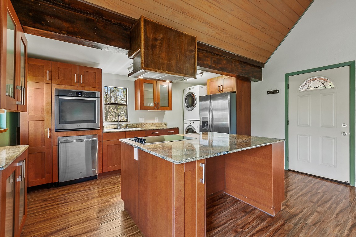 4301 Stearn's Lane Austin, TX 78745 - Photo 13 of 39 a kitchen with stainless steel appliances granite countertop a sink a stove and a wooden floors