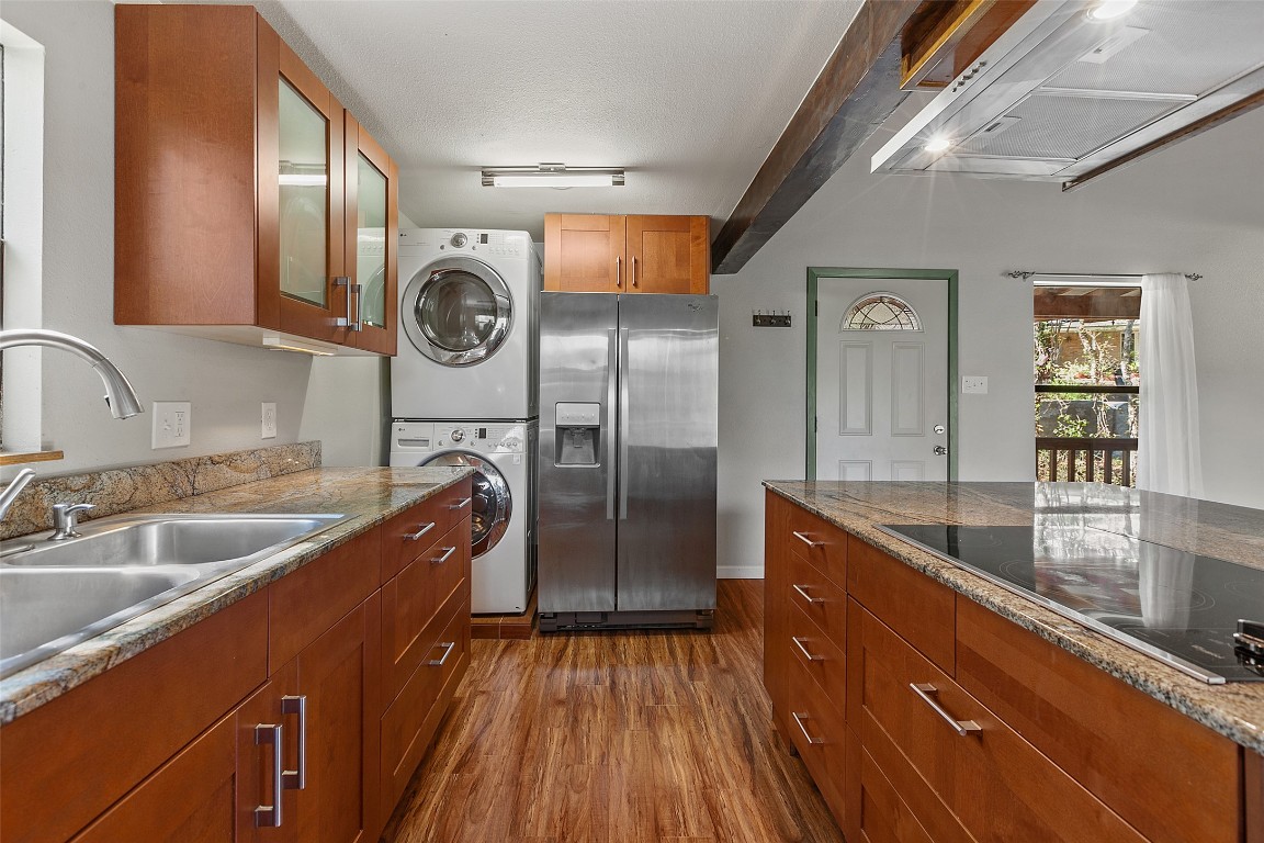 4301 Stearn's Lane Austin, TX 78745 - Photo 15 of 39 a kitchen with stainless steel appliances granite countertop a sink a refrigerator and wooden floor