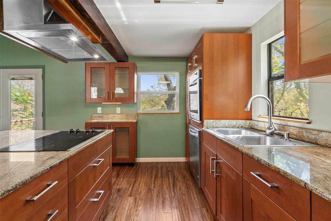 4301 Stearn's Lane Austin, TX 78745 - Photo 18 of 39 a kitchen with granite countertop a sink and wooden cabinets