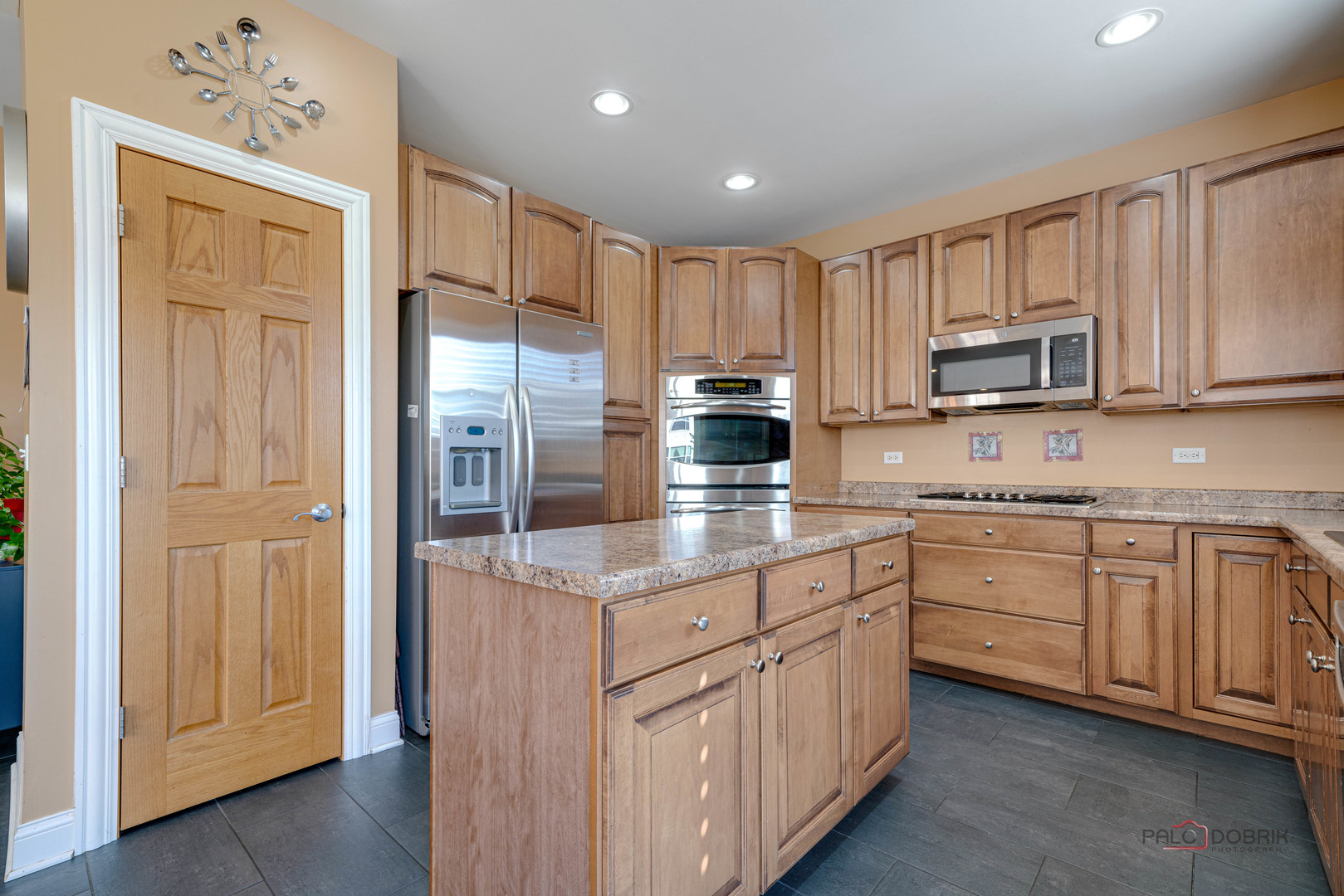 288 Shelbourne Road Volo, IL 60073 - Photo 8 of 33 a kitchen with stainless steel appliances granite countertop a refrigerator sink and cabinets