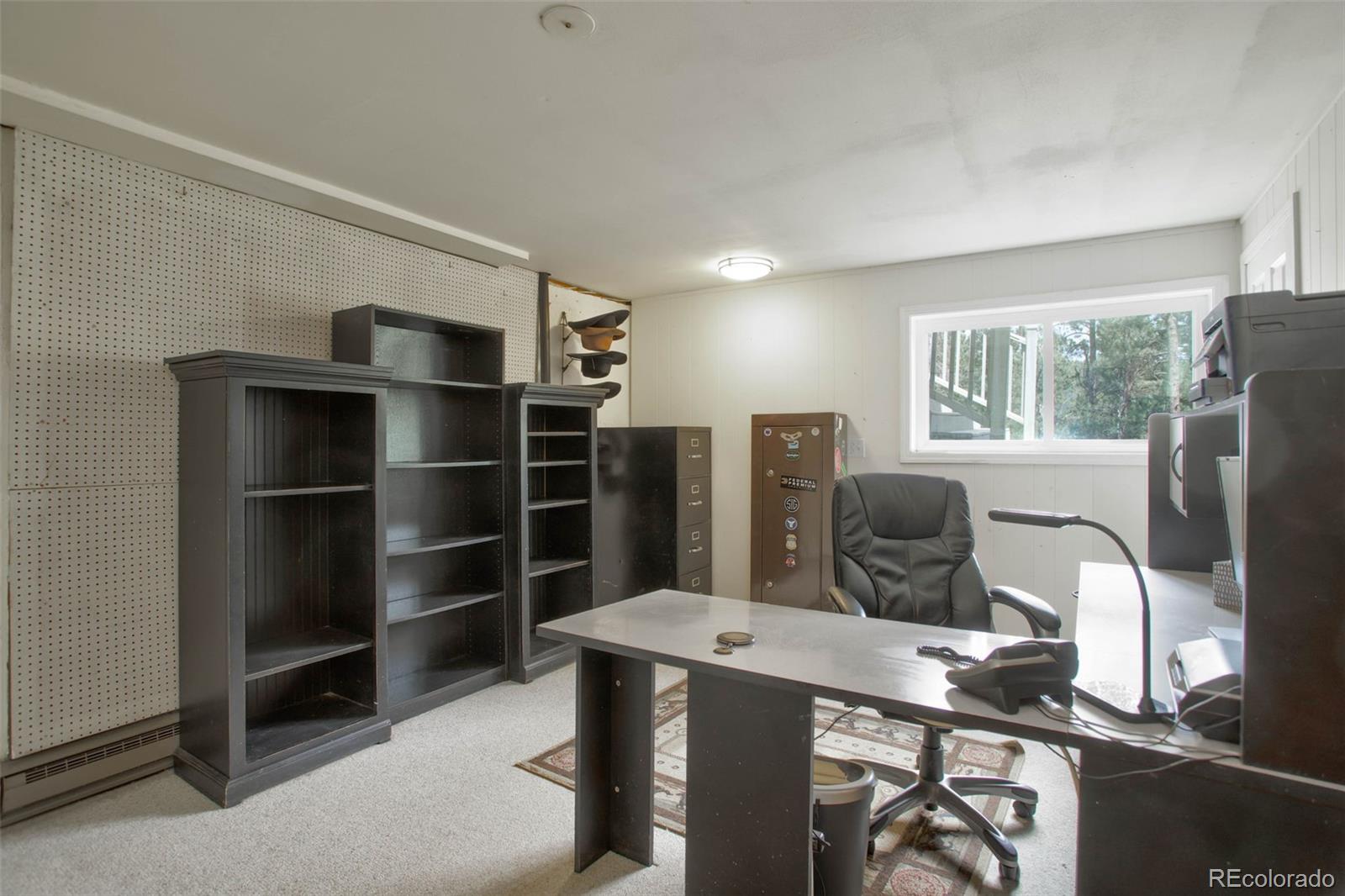 12079 Tecumseh Trail Conifer, CO 80433 - Photo 12 of 38 a view of a workspace with furniture and windows