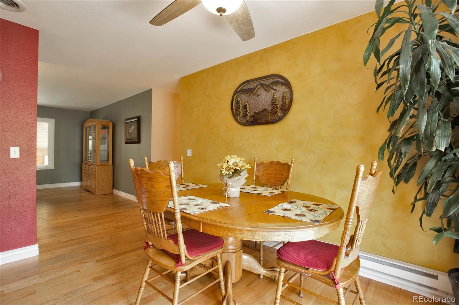 12079 Tecumseh Trail Conifer, CO 80433 - Photo 15 of 38 a view of a dining room with furniture and wooden floor
