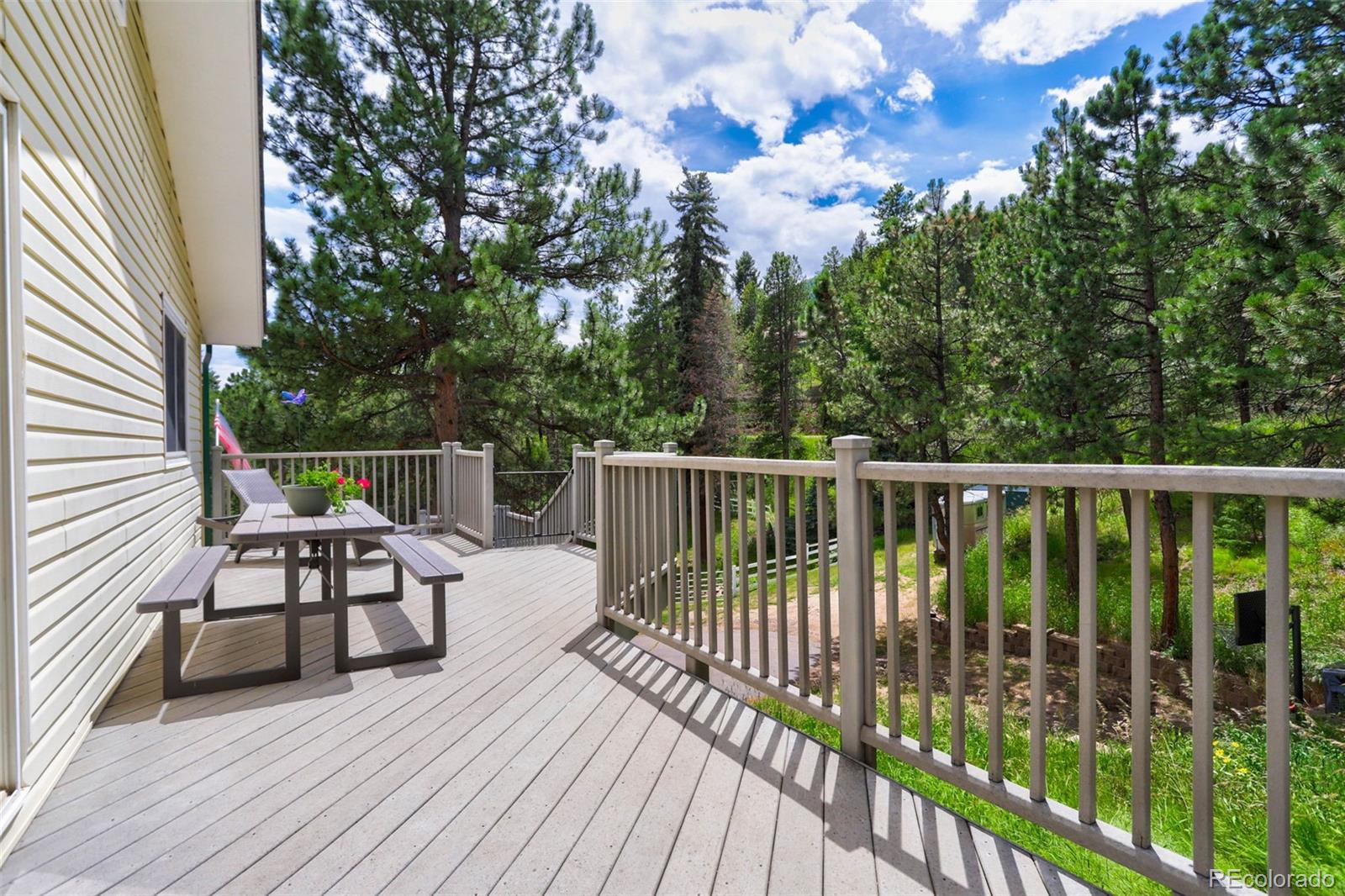 12079 Tecumseh Trail Conifer, CO 80433 - Photo 19 of 38 a view of a two chairs with wooden fence