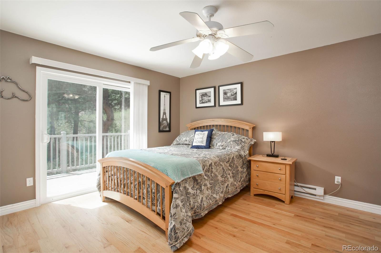 12079 Tecumseh Trail Conifer, CO 80433 - Photo 20 of 38 a bedroom with a bed and a large window