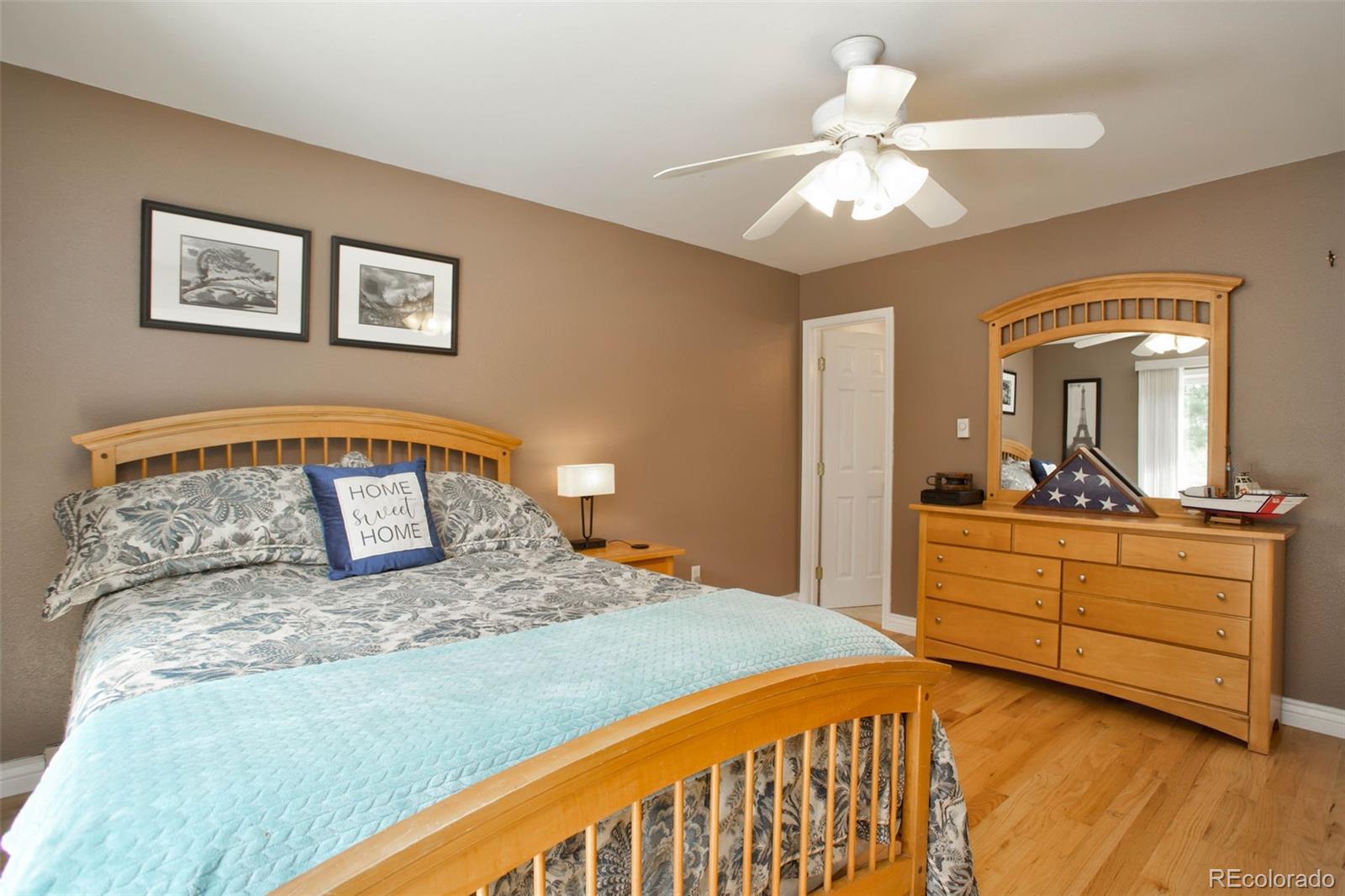 12079 Tecumseh Trail Conifer, CO 80433 - Photo 21 of 38 a bedroom with a large bed and a chandelier