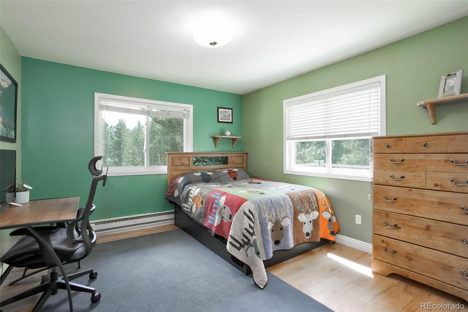 12079 Tecumseh Trail Conifer, CO 80433 - Photo 23 of 38 a bedroom with a bed and a window