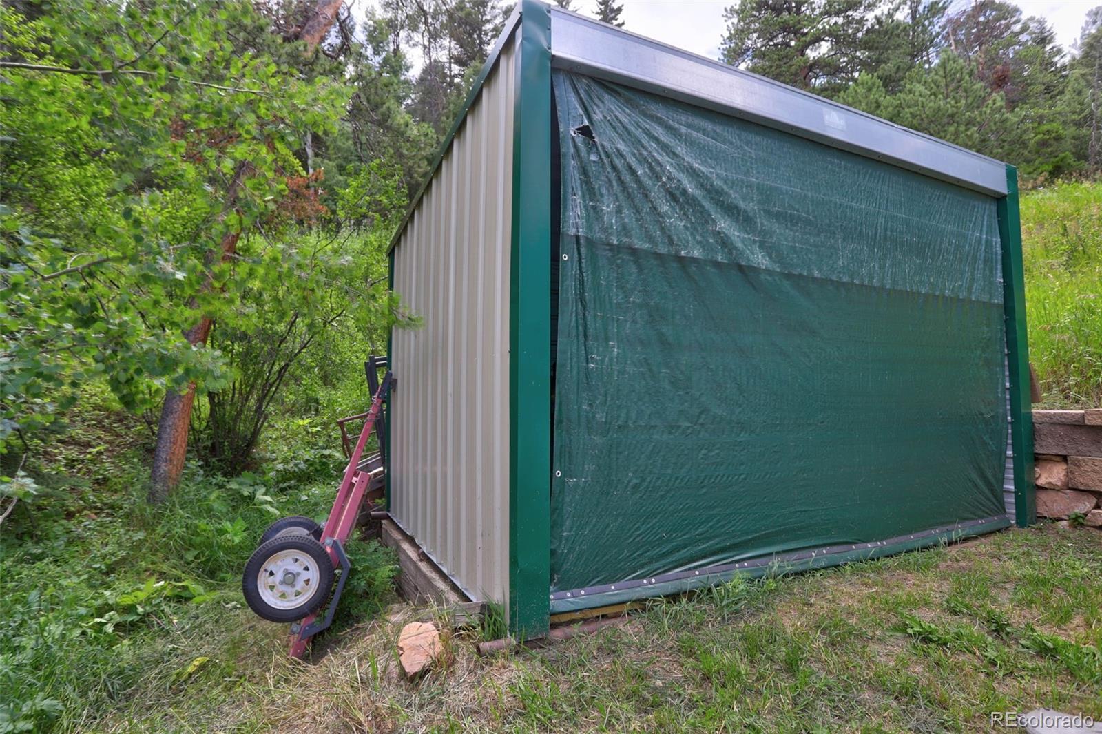 12079 Tecumseh Trail Conifer, CO 80433 - Photo 31 of 38 a backyard of a house with lots of green space