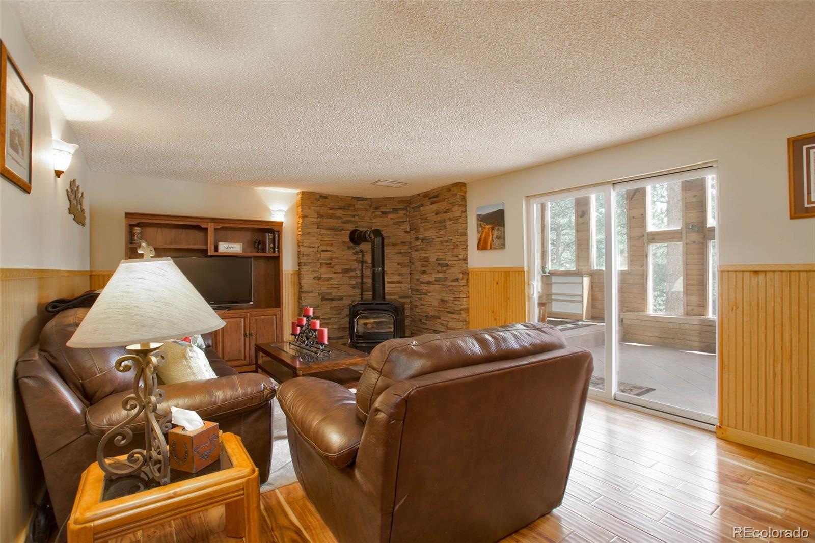 12079 Tecumseh Trail Conifer, CO 80433 - Photo 9 of 38 a living room with furniture and wooden floor