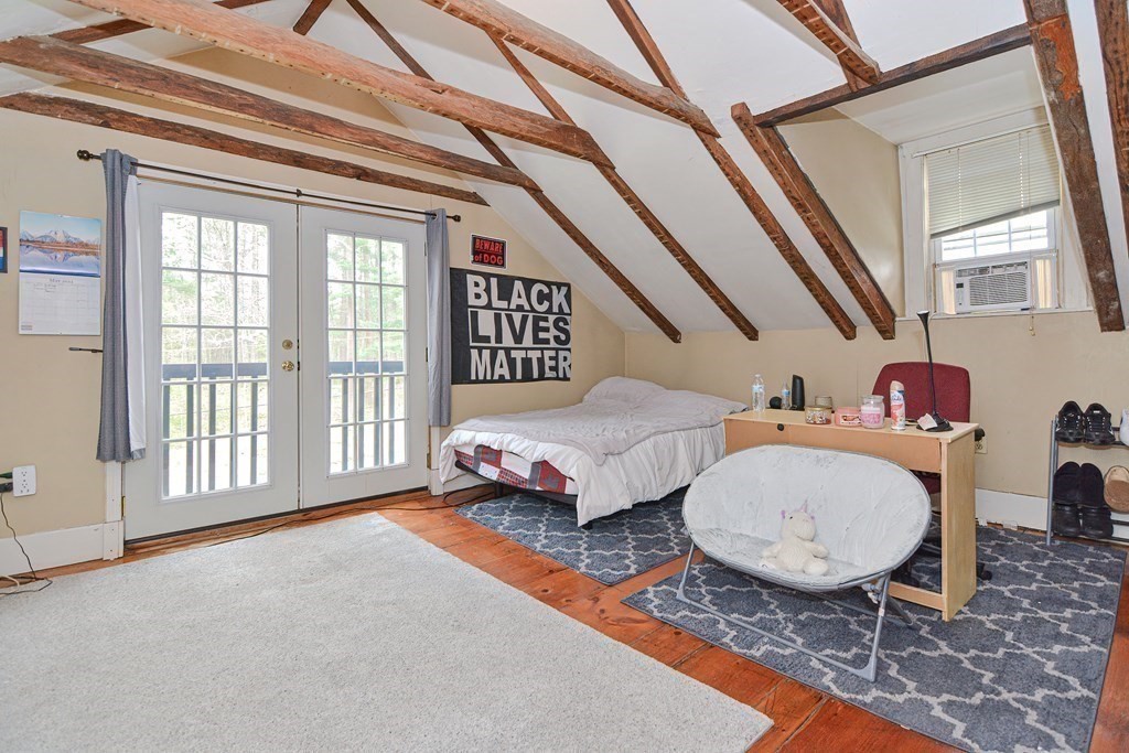 34 South Spencer Road Spencer, MA 01562 - Photo 26 of 34 a spacious bedroom with a bed a chandelier and windows
