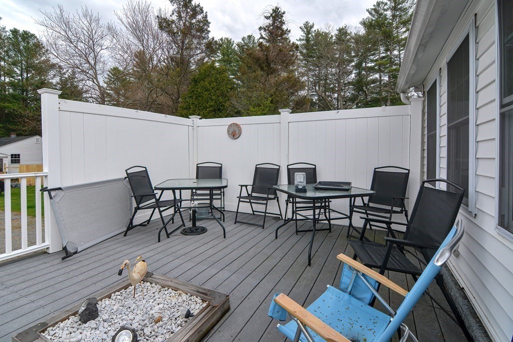 34 South Spencer Road Spencer, MA 01562 - Photo 31 of 34 a view of a patio with table and chairs with wooden floor and fence