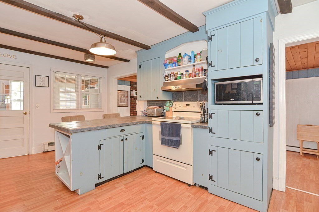 34 South Spencer Road Spencer, MA 01562 - Photo 7 of 34 a kitchen with granite countertop cabinets stainless steel appliances and wooden floor
