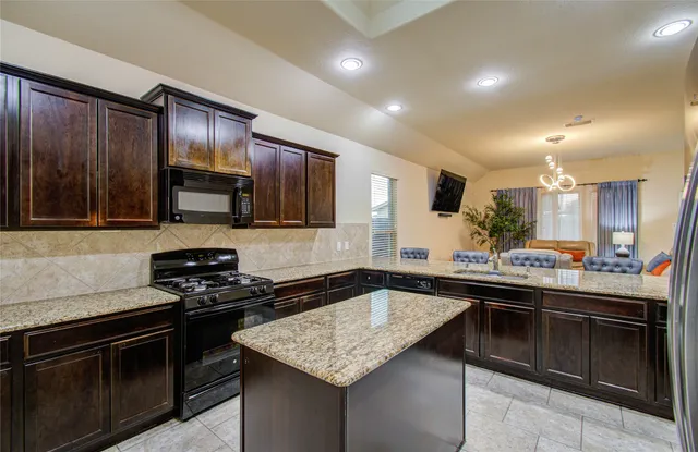 a kitchen with a sink stove and microwave