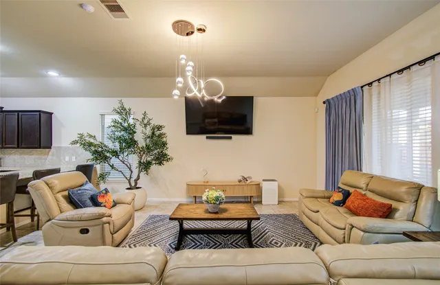 a living room with furniture and a flat screen tv
