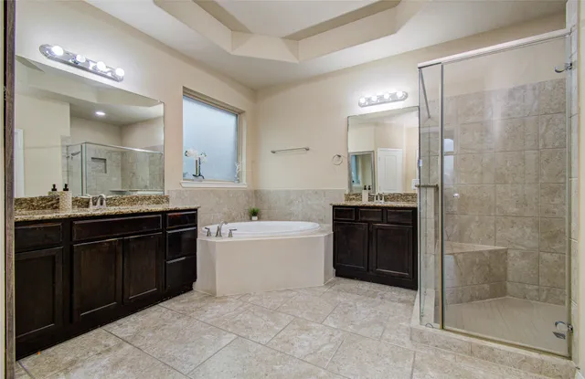 a large bathroom with a sink a large mirror and a shower