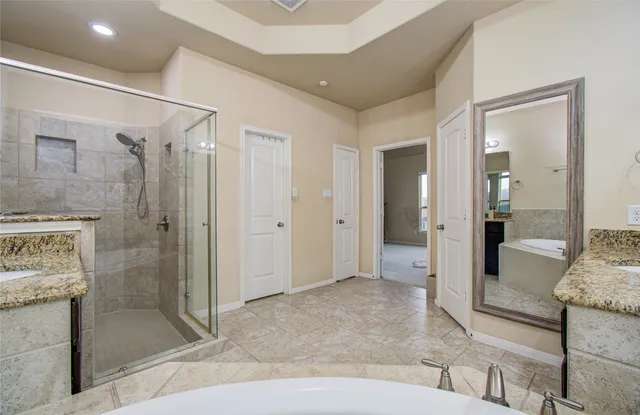 a living room with furniture and a glass door shower