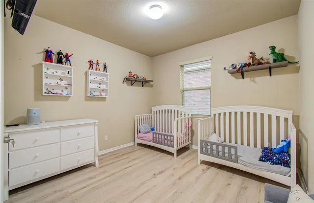 a bedroom with furniture and a window