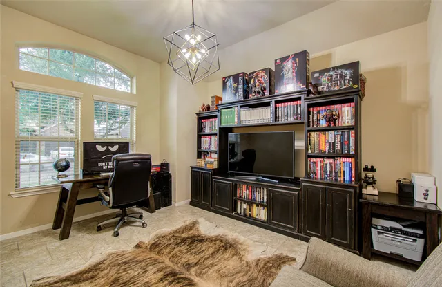 a view of a livingroom with workspace and a window