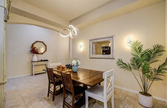 a view of a dining room with furniture and chandelier