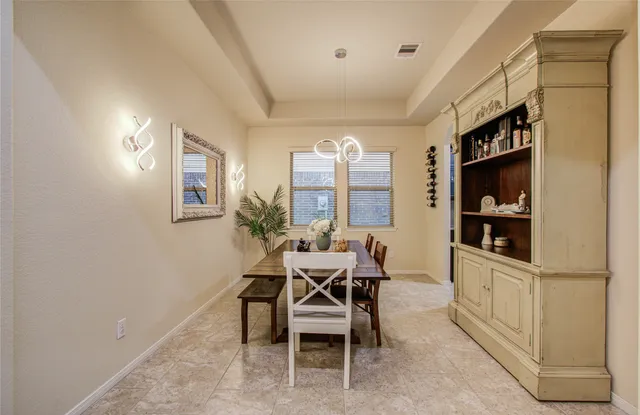 a dining room with furniture and a window