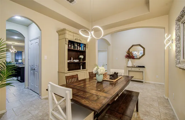 a dining room with furniture and chandelier